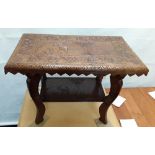 An Indian 2-tiered coffee table carved with elephants.