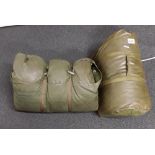 A 1968 and a 1972 British military green one-man sleeping bags.