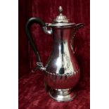 A silver ribbed baluster shaped coffee pot.