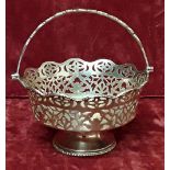 A silver bonbon basket with pierced decoration and handle.