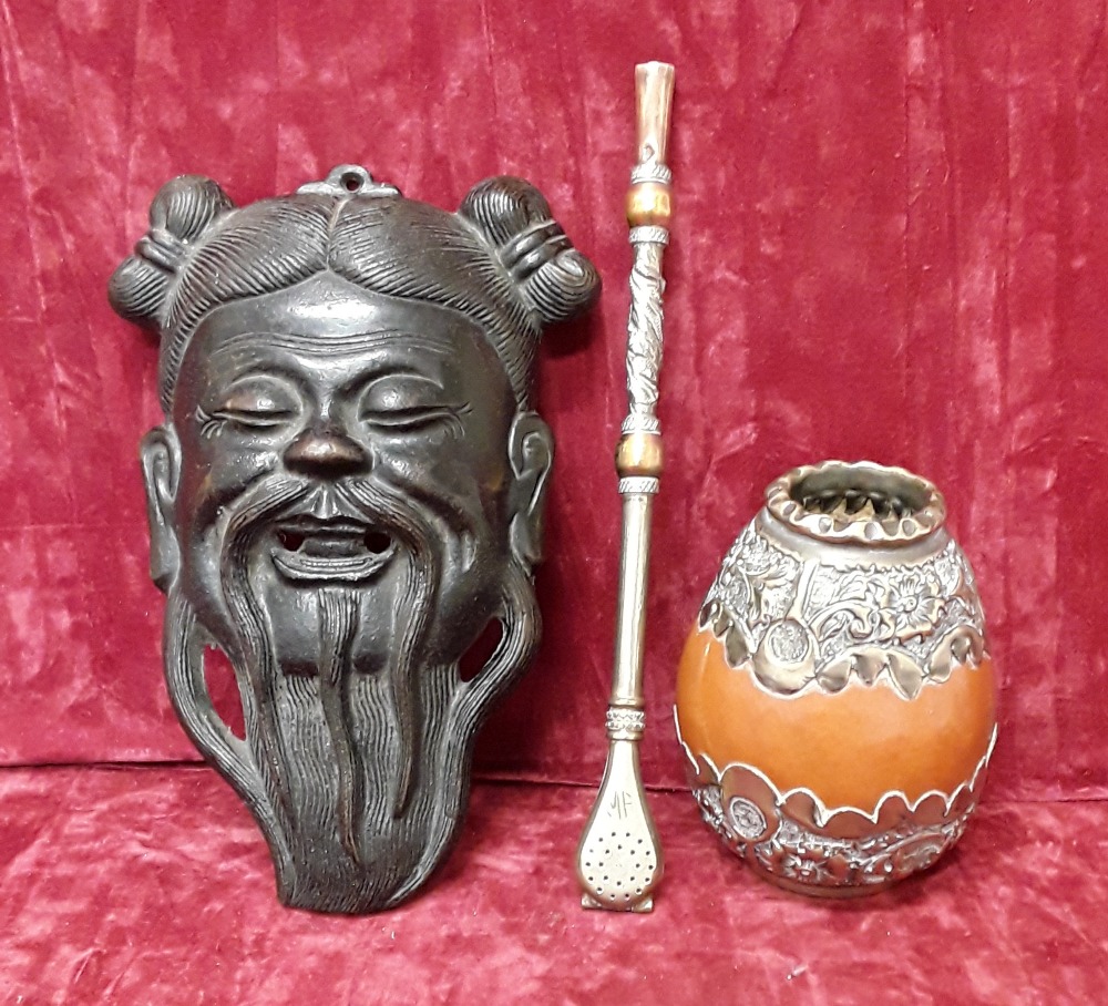 A blackened copper Japanese hip mask and an Alpaca opium smoking bowl and pipe.