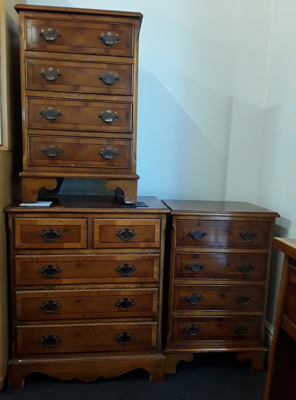 A set of three small chest of drawers.