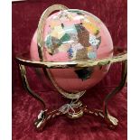 A pink ocean acrylic "gemstone" political world globe with full meridian.