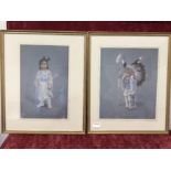 A pair of framed and glazed prints of native American Indian children in tribal dress.