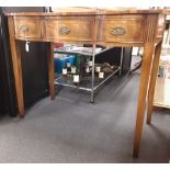 A small writing desk with leather insert and bow front.