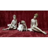 A collection of three Lladro Nao figurines showing ballerinas in various poses.