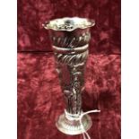 A silver embossed posy vase.