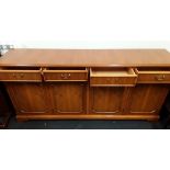 A contemporary yew sideboard with four drawers above four cupboards.