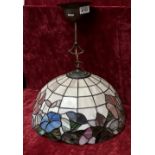 A vintage Tiffany style lamp shade and fittings of with blue, pink and green flowers.