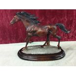 A Spanish resin hand painted horse mounted on a plinth.