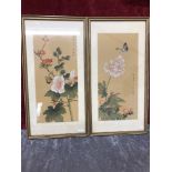 A pair of Chinese paintings on silk depicting flowers and butterflies signed to the side.