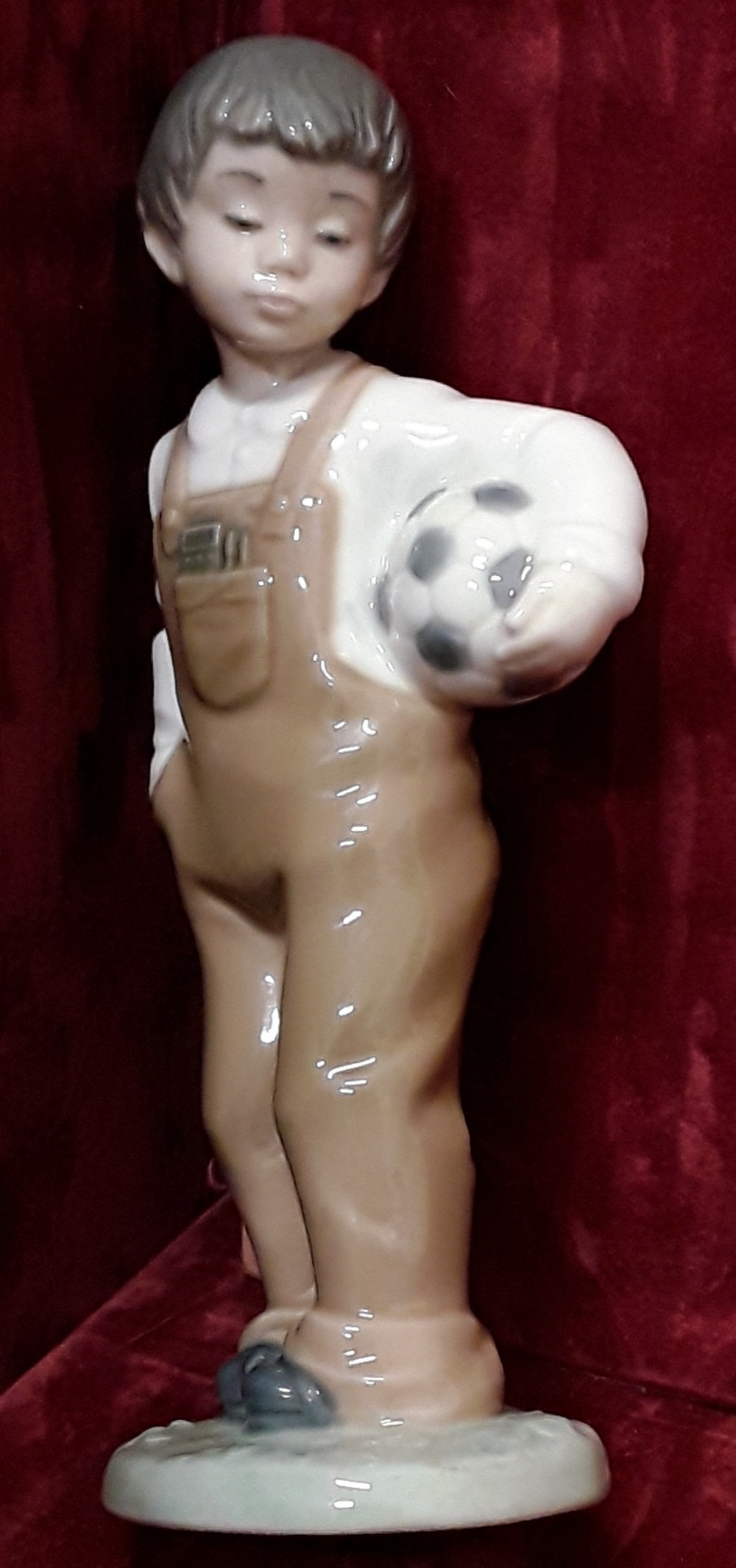 A Lladro Nao Daisa 1988 figurine of boy with a football. - Image 2 of 4