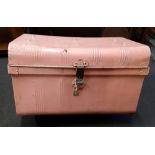 A large painted pink metal trunk