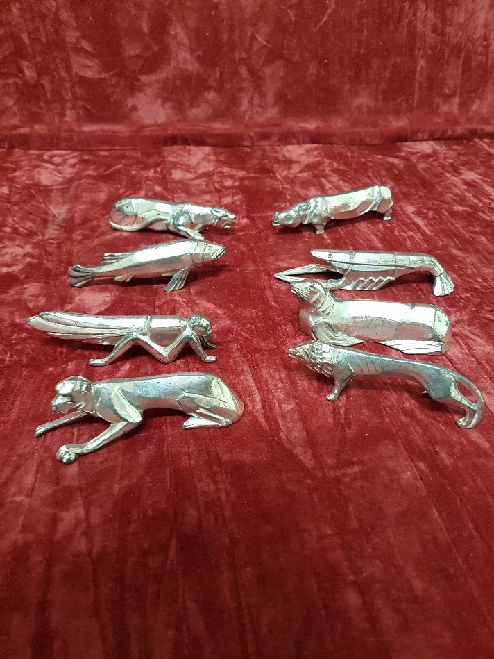 A set of eight Cubist white metal knife rests (Arts and Crafts).