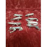 A set of eight Cubist white metal knife rests (Arts and Crafts).