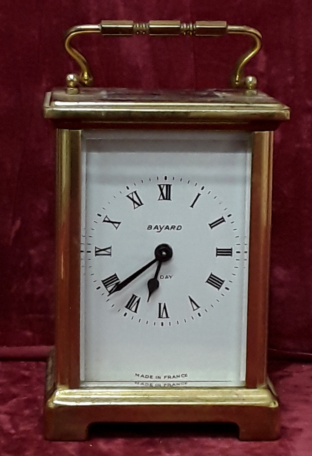 A brass carriage clock stamped Duverdrey and Bloquel France to the base.