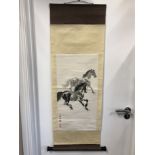 A Chinese scroll depicting two galloping horses signed to the side