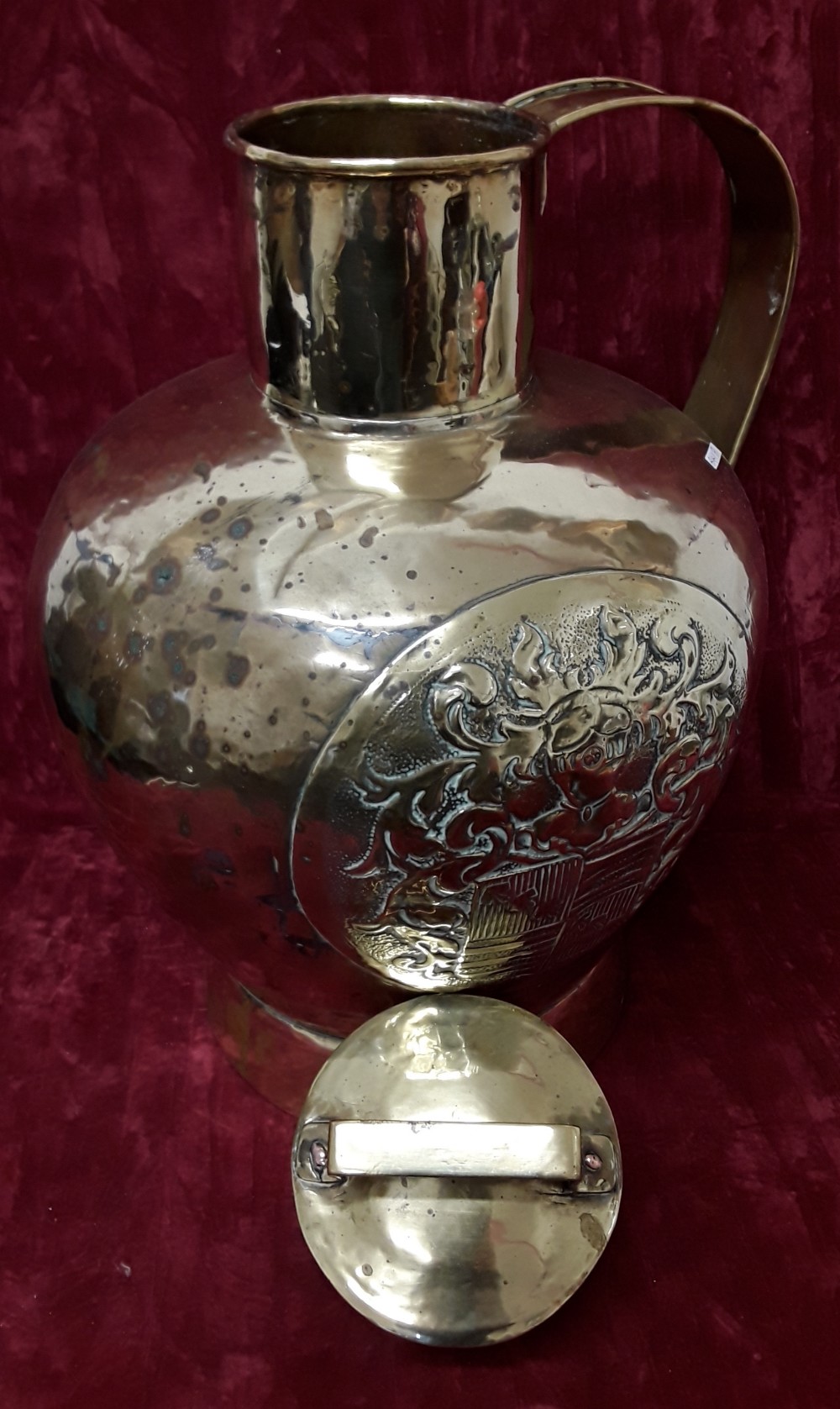 A very large antique brass container with handle and lid.