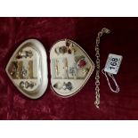 A heart shaped jewellery box containing a collection of costume and silver jewellery.