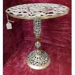 A small brass table with ornate lattice top.