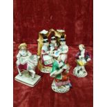 A small collection of ceramic figures plus a small posy vase in the form of three ladies from Wales.