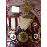 An unnamed WW1 British Red Cross Society For War Service medal with other BRCS badges etc.