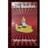 A first edition copy of the "The Beatles Yellow Submarine" paperback book.