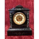 A marble eight day mantel clock.