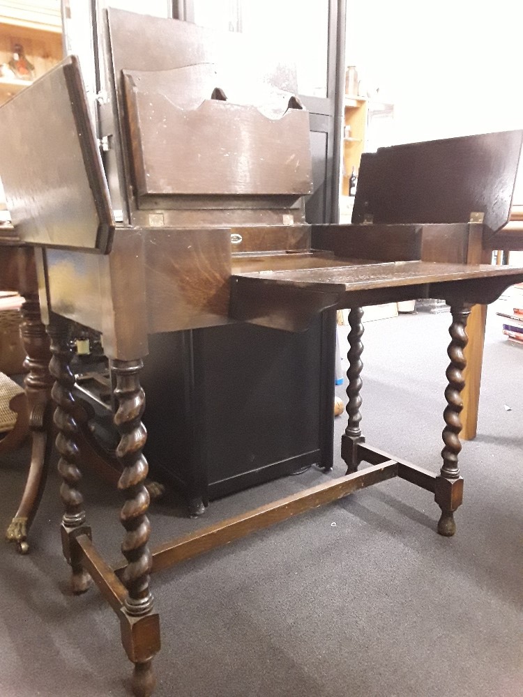 A small early 20th Century oak fold-out writing desk.