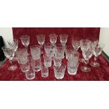 A collection of 26 drinking glasses of various forms.