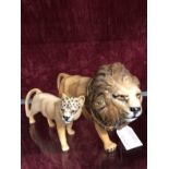 A Beswick lion and lioness.