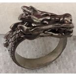 A white metal ring in the form of a dragon.