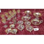 A collection of vintage glassware with gold gilt decoration.