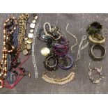 A box of costume jewellery – mostly necklaces and bracelets.