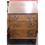 A 1930s oak bureau with a drop down leaf