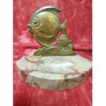 A set of bronze fish mounted on a shaped marble base.