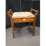 An Edwardian oak piano stool.