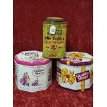 A collection of three tins containing building blocks, playing cards etc.