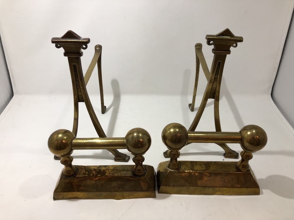 Two pairs of brass fire dogs including Art Deco.