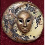 A Venetian mask with moon features.