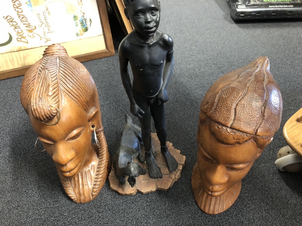 An assortment of carved wooden African animals and figures.