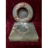 Two green onyx ashtrays one circular and one square.