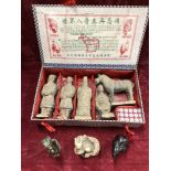 A souvenir box of miniature terracotta figures plus three miniature figures.