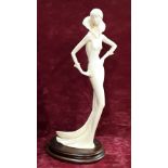A signed Amilcare Santini faux ivory figure of an elegant lady on an oak base.