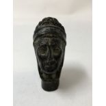 A bronze walking stick handle in the form of a Roman soldier.