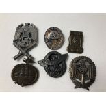 An assortment of six Nazi badges.