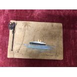 A pre 1940 leather covered photograph album with a hand painted view of the S.S. Montcalm.