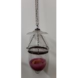 A suspended hand blown glass candle holder.