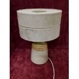 An earthen wear lamp with cylindrical sued effect lamp shade