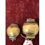 Two small brass hinged powder containers.